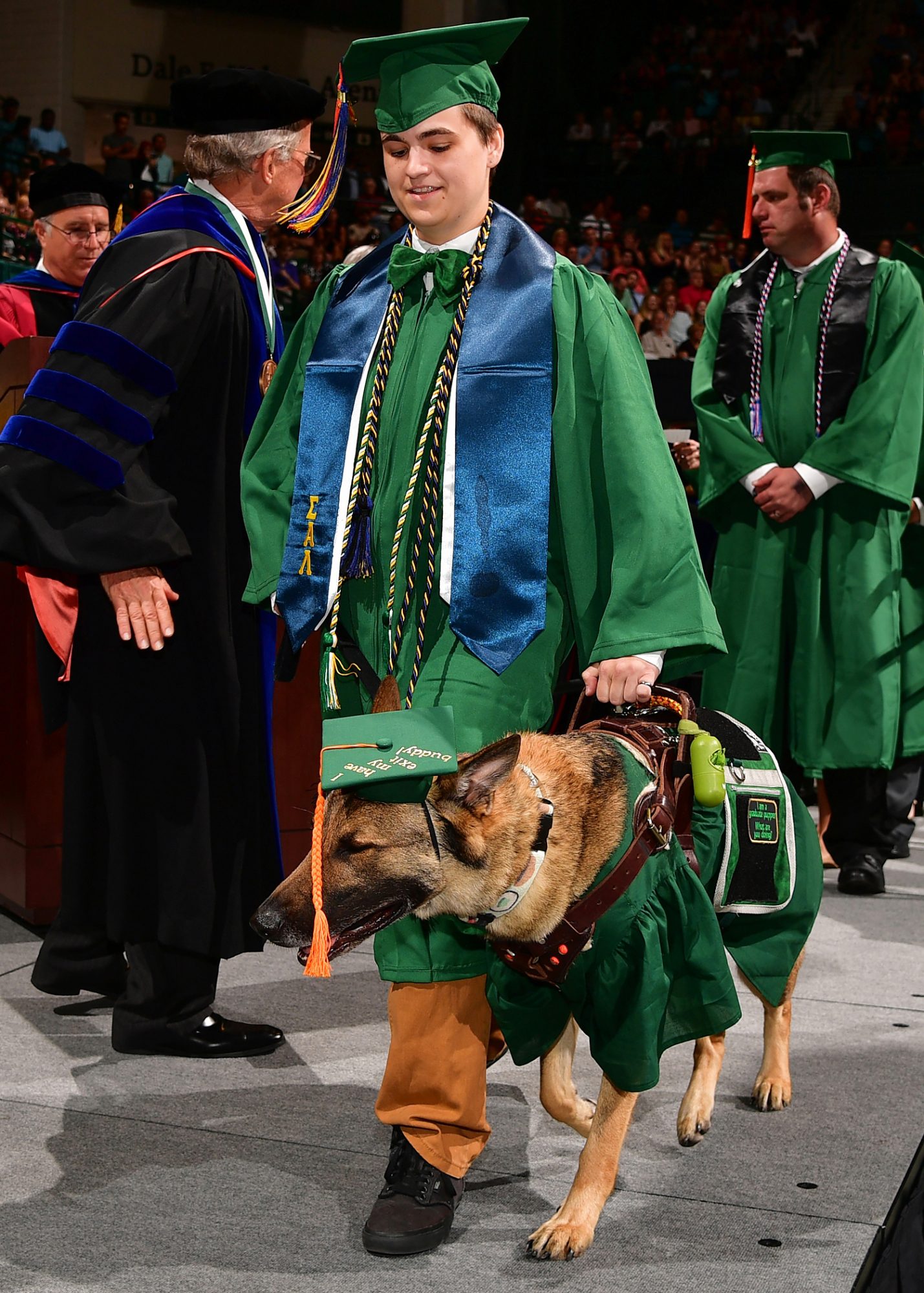 Graduate with service dog at UNC Charlotte Spring 2018 Commencement